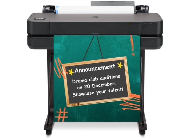 School staff using a poster maker printer to create colorful educational posters in a classroom setting.