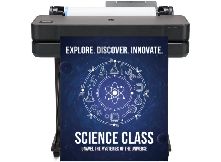 Teacher using a school poster making machine to print a large educational chart.