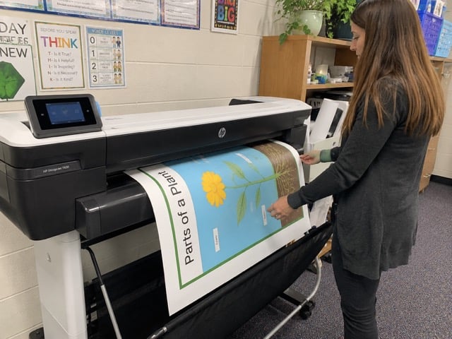 Educator printing a poster with a school poster maker